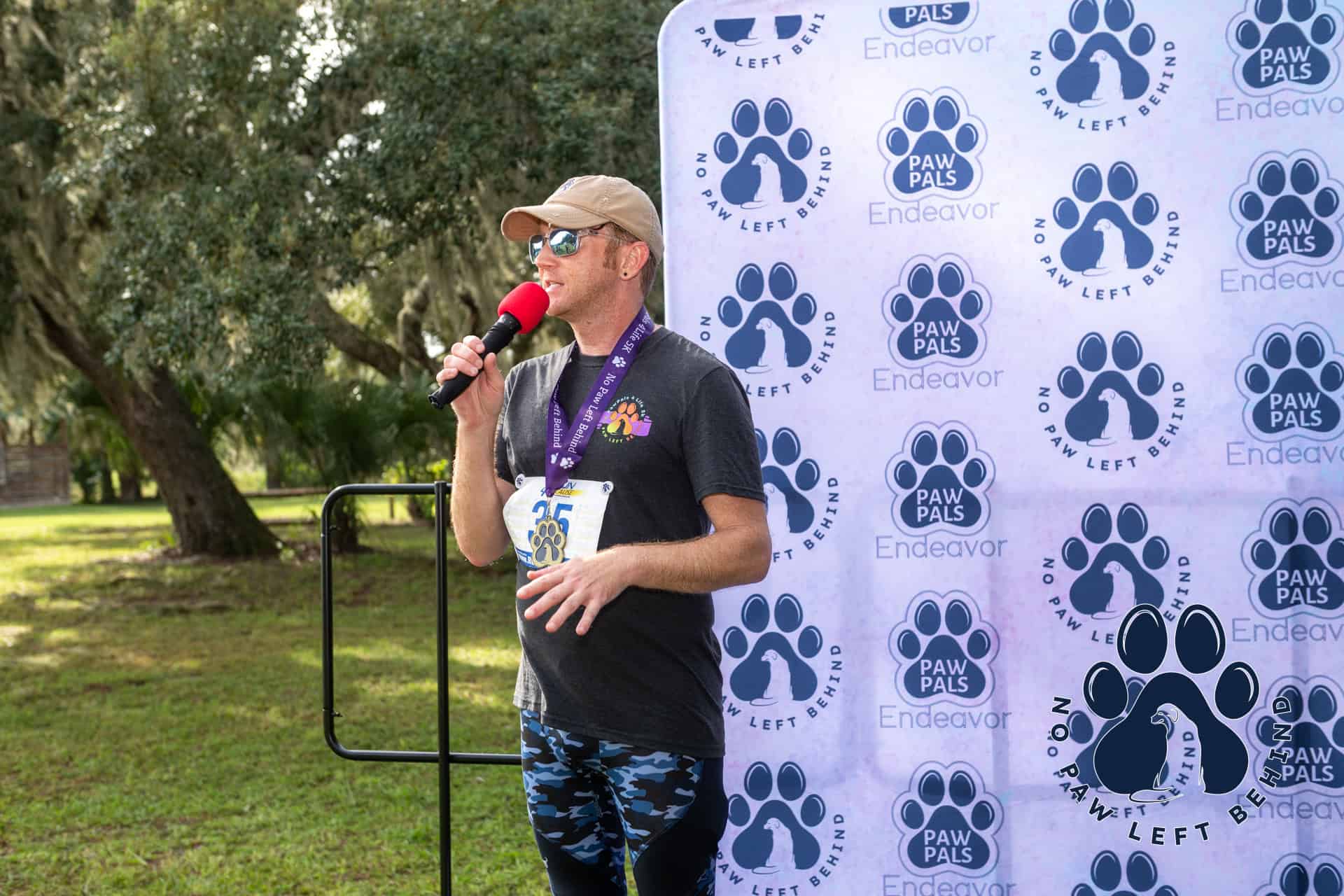 Event host speaking to the audience and thanking sponsors of the event.