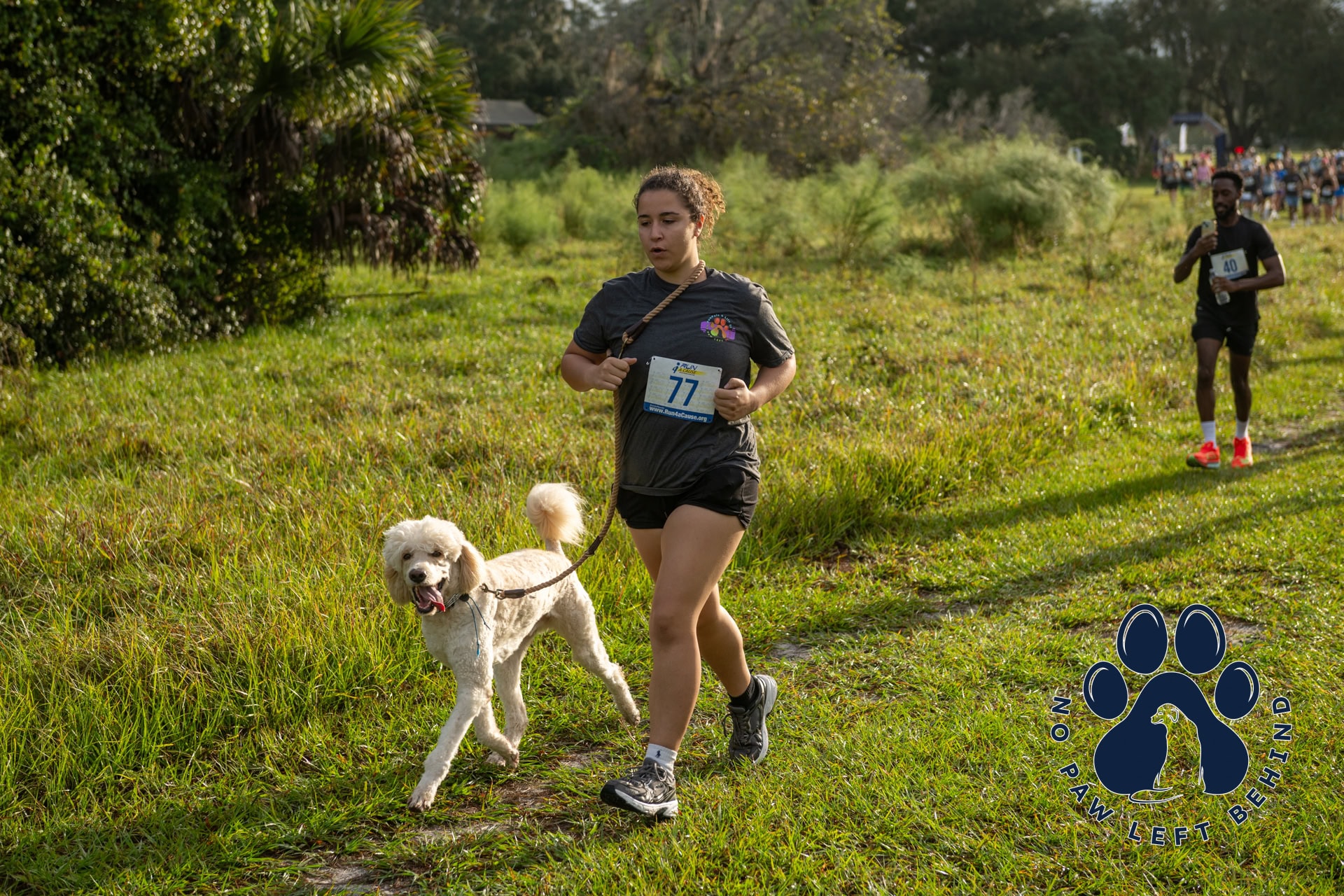 Runner with dog at PawPals 5K event. This event is organized by Disruptive Endeavors
